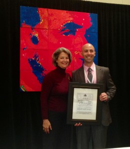 Janet Stover, CEO of IARF presenting GBFC President/CEO John Pingo with the Champion Award.