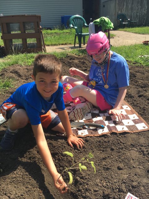 Lincoln and Jessica planting together.